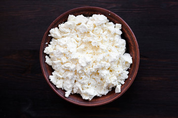 Delicious homemade cottage cheese on the wooden table