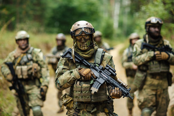 soldiers standing with arms and looks back