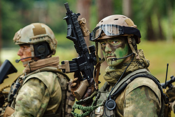 Fototapeta premium soldier stands with arms and looks forward