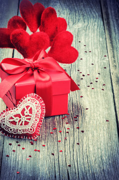 Valentine's setting with gift box and red hearts decorations