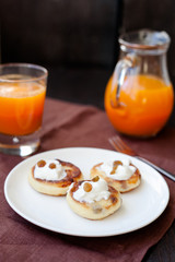 Delicious homemade cheese pancakes with fresh carrot juice