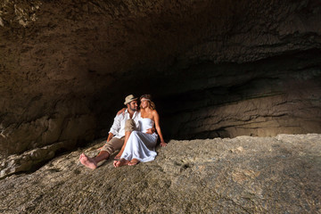 young couple in love inside a cave