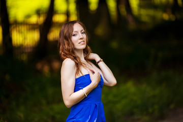 Fototapeta premium Young cheerful woman posing in park