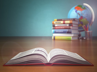 Concept of education. Open book wich pencils and globe.