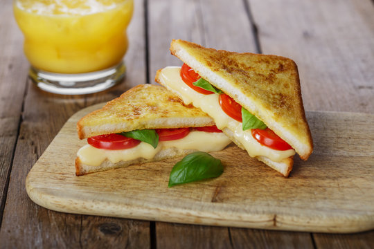 Fototapeta fried toast sandwich with mozzarella and cherry tomatoes