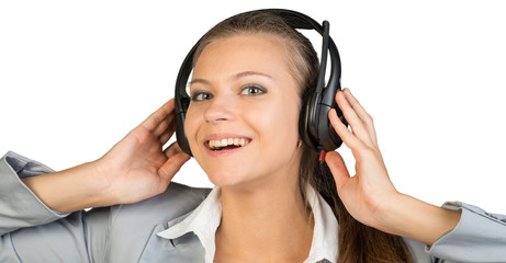 Businesswoman in headset with her hands on speakers