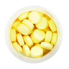 top view of yellow pills in round plastic bottle