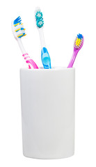 three tooth brushes in ceramic glass