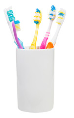 five toothbrushes in ceramic glass