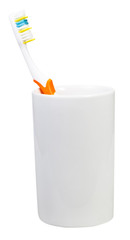 one orange tooth brush in ceramic glass