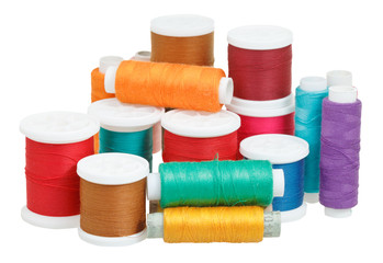 multicolored thread bobbins isolated on white