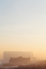 Fototapeta na wymiar yellow and blue sunrise sky over urban houses