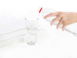 woman hands pouring fresh blue water from bottle