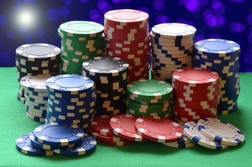 Red, blue, green, white and black poker chips pile