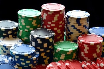 Red, blue, green, white and black poker chips pile