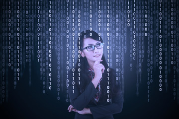 Businesswoman looking at binary code