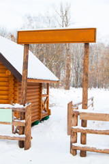 wooden sign board and fence in winter snow