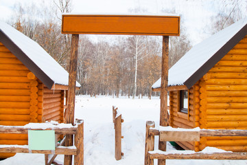 sign board and new yellow wooden house in winter forest