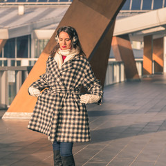 Beautiful young brunette posing in the city streets