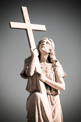 Statue of woman with cross