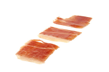 Three spanish serrano ham slices isolated on white background.