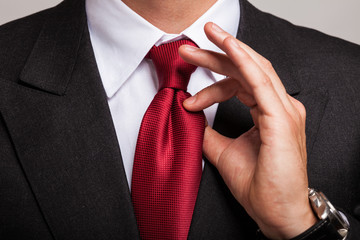 Businessman adjusting his necktie