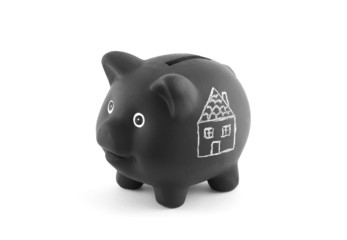 Black piggy bank with drawing of house. Clipping path included.