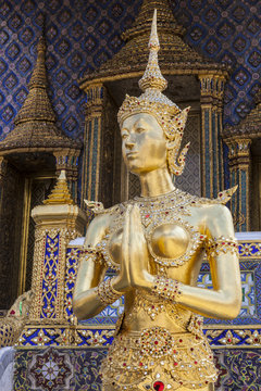 a graceful golden kinaree image on blue sky background, Thai myt