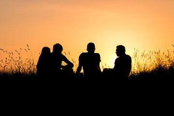 Fototapeta na wymiar group of teenagers watching sunset