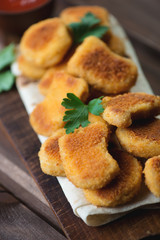 Close-up of chicken nuggets with fresh parsley, vertical shot