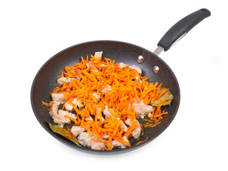 Fried meat with carrots in the pan