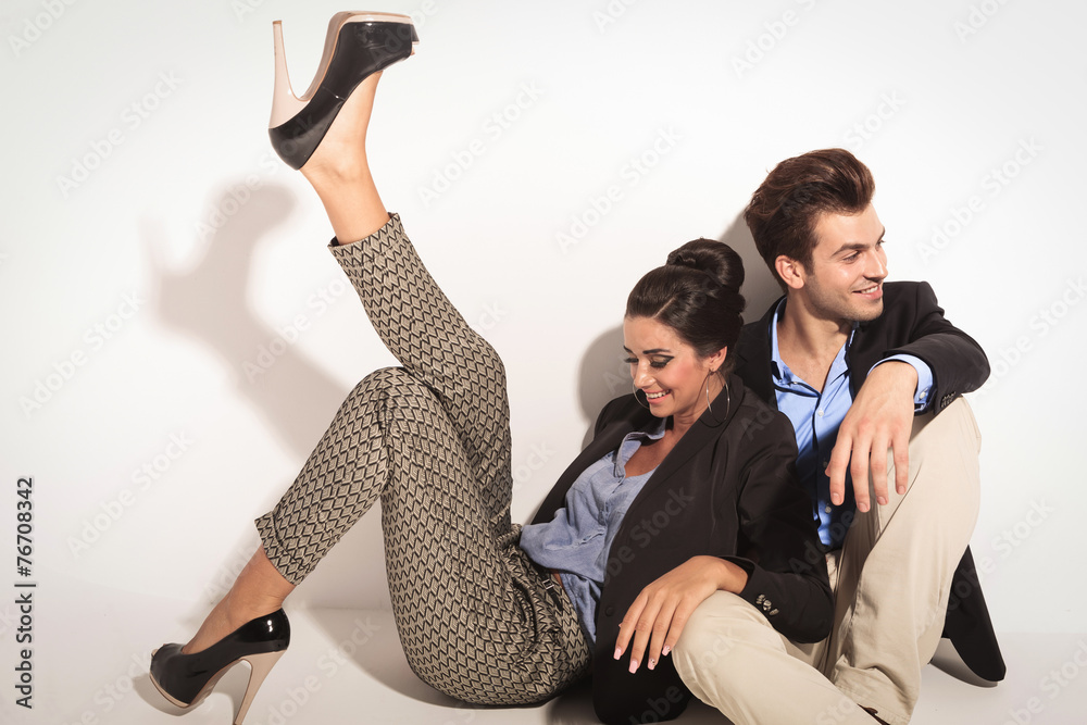 Canvas Prints Happy fashion couple sitting together on the floor