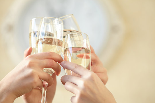 Glasses of champagne in female hands on a party