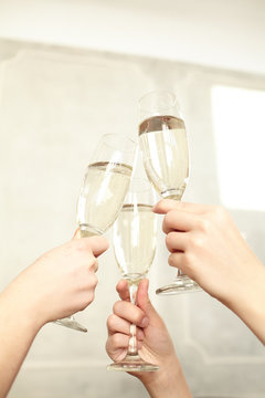 Glasses of champagne in female hands on a party