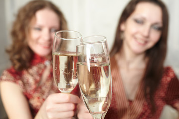 beautiful girls at a Christmas party with glasses of champagne
