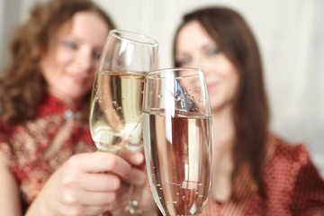 beautiful girls at a Christmas party with glasses of champagne