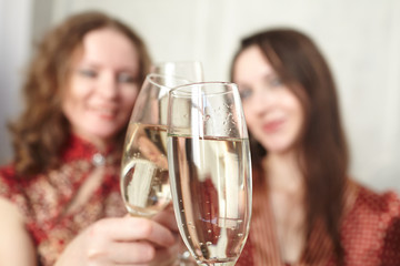 beautiful girls at a Christmas party with glasses of champagne