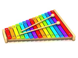 Xylophone with rainbow colored keys and with two wood drum stick
