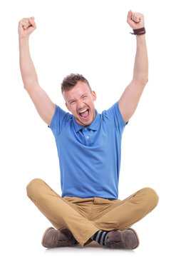 seated young casual man cheering