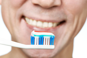 Man brushing teeth toothbrush with toothpaste