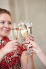 beautiful girls at a Christmas party with glasses of champagne