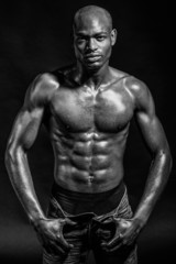 Fototapeta na wymiar Athletic black man on black background