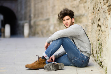 Man wearing suspenders in urban background