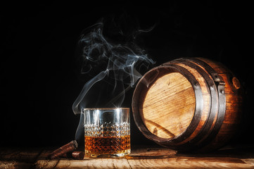 Glass of alcohol and smoking noble cigar on a black background - 76720174
