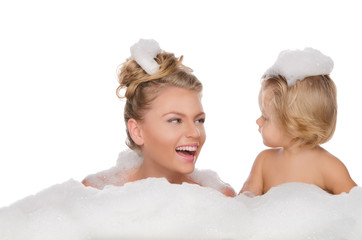 Smiling mother with her daughter and soap foam