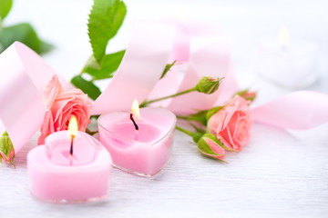 Fototapeta na wymiar Valentine's Day. Pink heart shaped candles and rose flowers