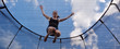 Young woman jumps on a trampolin