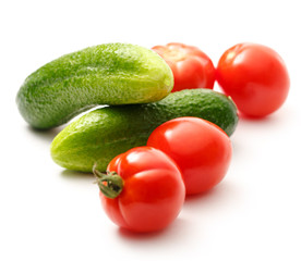 Fresh cucumbers and tomatoes on white