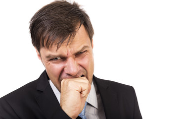 Angry businessman biting his fist