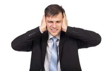 Annoyed businessman covering his ears with his hands